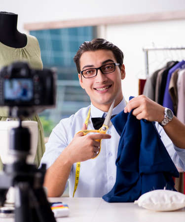 Young man working as fashion video bloggerの写真素材