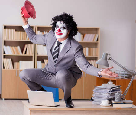 Clown businessman working in the officeの写真素材