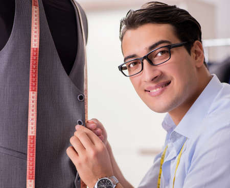 Young man tailor working on new clothingの写真素材