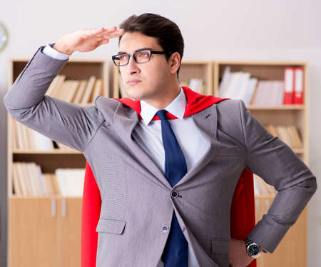 Superhero businessman working in the officeの写真素材