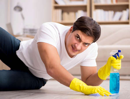 Man husband cleaning the house helping wifeの写真素材