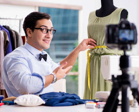 Young man working as fashion video bloggerの写真素材