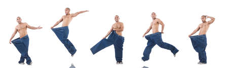 Man in dieting concept with oversized jeansの写真素材