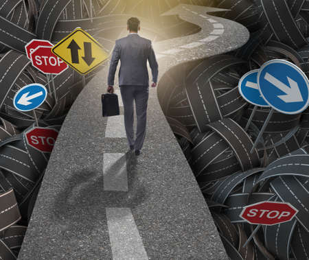 Businessman in uncertainty concept on road intersection crossroa
