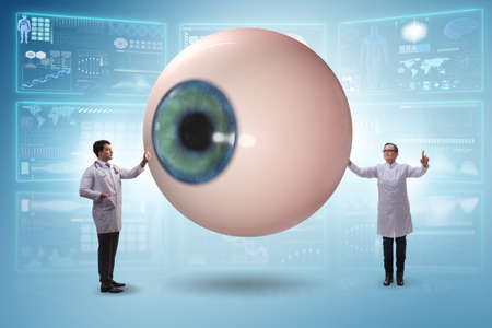 Doctor examining giant eye in medical conceptの写真素材