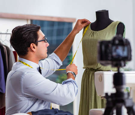 Young man working as fashion video bloggerの写真素材