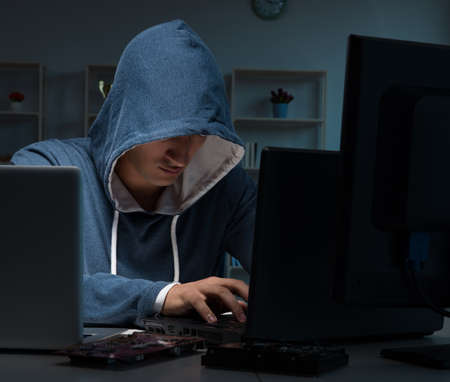 Hacker hacking computer at night