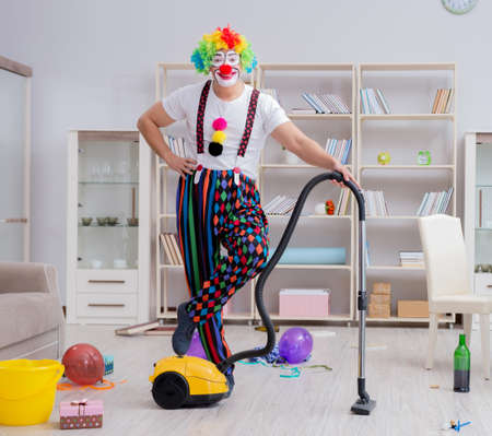 Funny clown doing cleaning at homeの写真素材