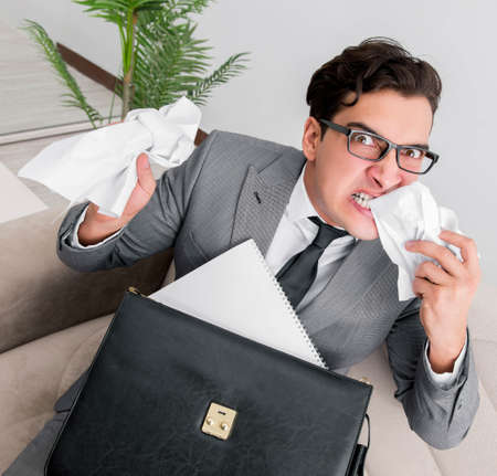 Angry businessman with crumbled paperの写真素材