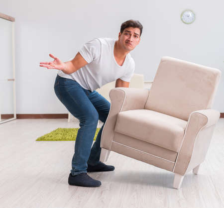 Man moving furniture at homeの写真素材