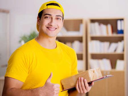 Delivery man delivering parcel boxの写真素材