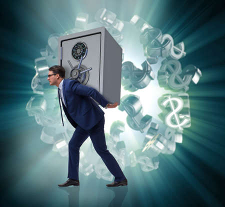 BUsinessman stealing metal safe from bankの写真素材