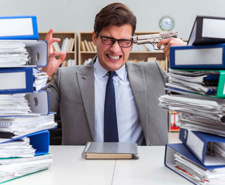 Businessman under stress due to excessive workの写真素材