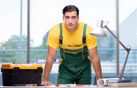 Construction worker sitting at the desk