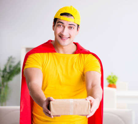 Superhero delivery guy with boxの写真素材