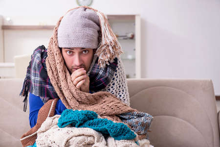 Young man suffering at homeの写真素材