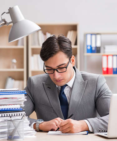Handsome businessman working in the officeの写真素材