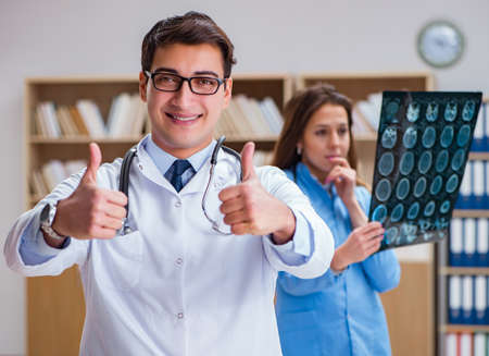 Young doctor looking at computer tomography x-ray image