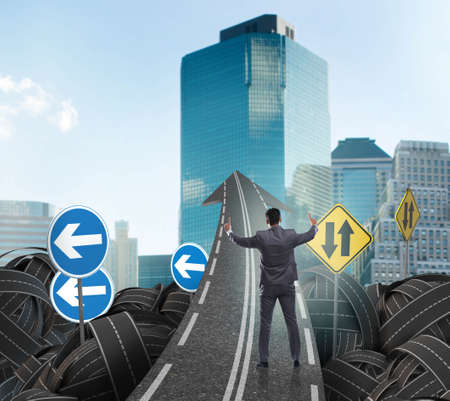 Businessman in uncertainty concept on road intersection crossroad