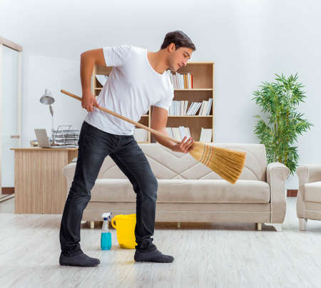 Man husband cleaning the house helping wife