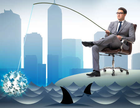 Businessman fishing out dollars from waterの写真素材