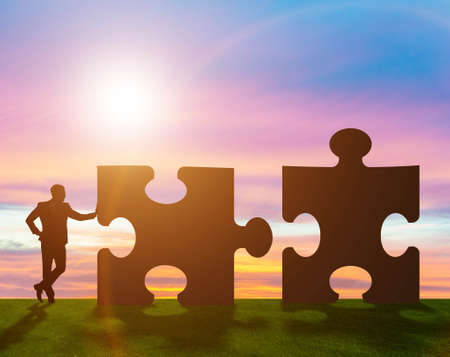 The business metaphor of teamwork with jigsaw puzzle