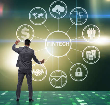 Businessman pressing buttons in fintech conceptの写真素材