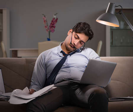 Businessman workaholic working late at home