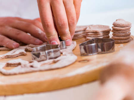 The young man cooking cookies in kitchenの写真素材