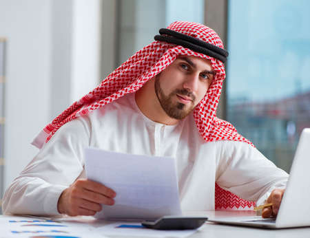 Arab businessman working on laptop computerの写真素材