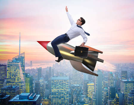 Businessman flying on rocket in business concept