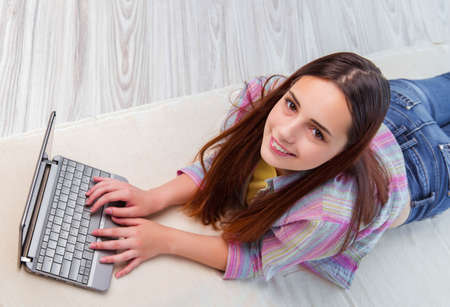 Young girl surfing internet on laptop