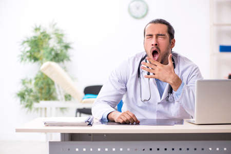 Young handsome male doctor working in the clinicの写真素材