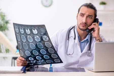 Young handsome male doctor working in the clinic