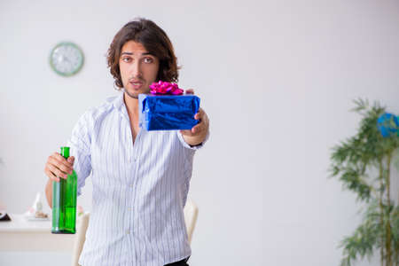 Young man celebrating his birthday at homeの写真素材