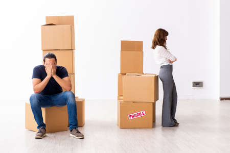 Young pair and many boxes in divorce settlement concept
