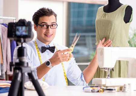 Young man working as fashion video bloggerの写真素材