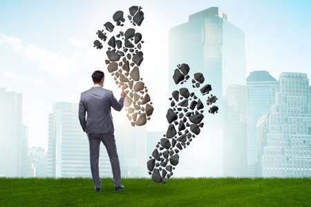 Carbon footprint concept with businessmanの写真素材