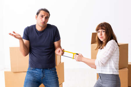 Young pair and many boxes in divorce settlement concept