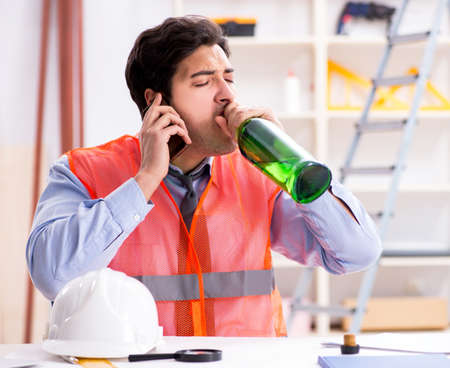 Drunk engineer working in the workshopの写真素材