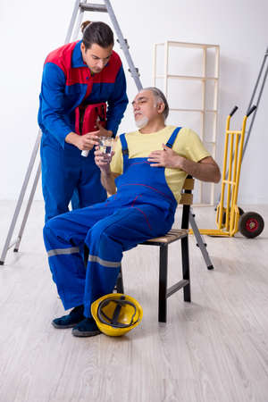 Two contractors in first aid conceptの写真素材