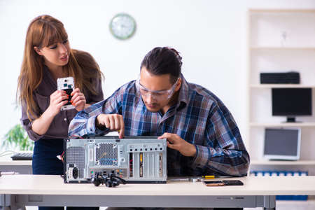 Two technicians working at computer warranty center