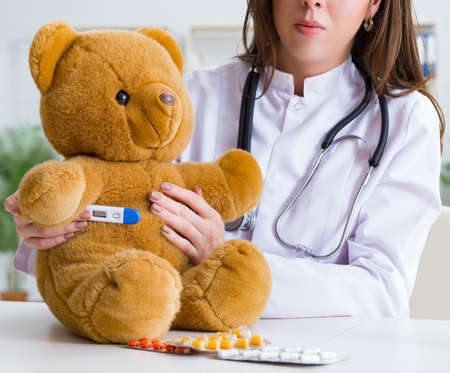 Child checking soft toy healthの写真素材