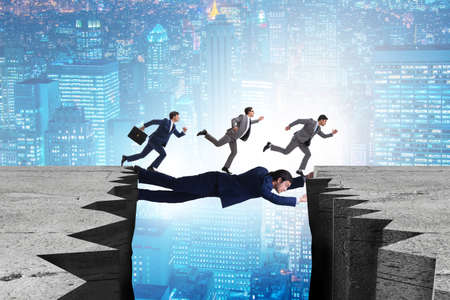 Businessman acting as a bridge in support conceptの写真素材