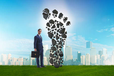 Carbon footprint concept with businessmanの写真素材