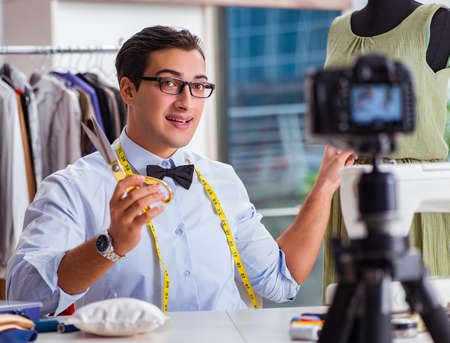 Young man working as fashion video bloggerの写真素材