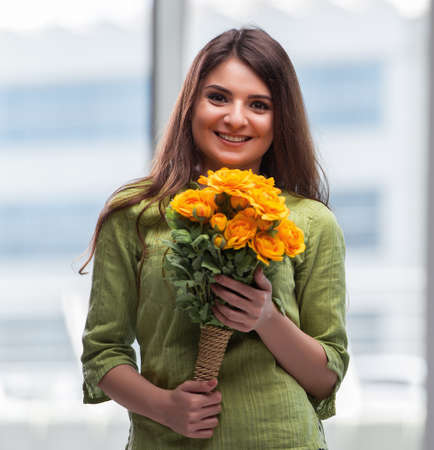 Young girl with present of flowersの写真素材