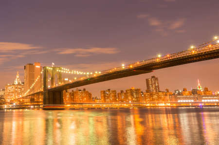 The night view of manhattan and brooklyn bridgeの写真素材