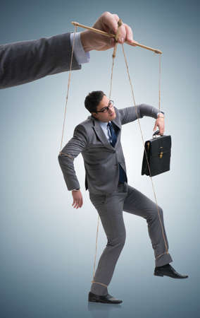 Businessman puppet being manipulated by bossの写真素材