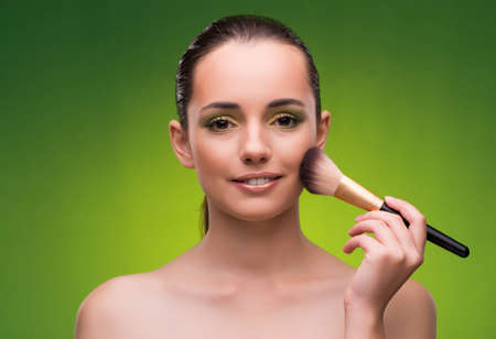 Young woman in beauty concept on green backgroundの写真素材